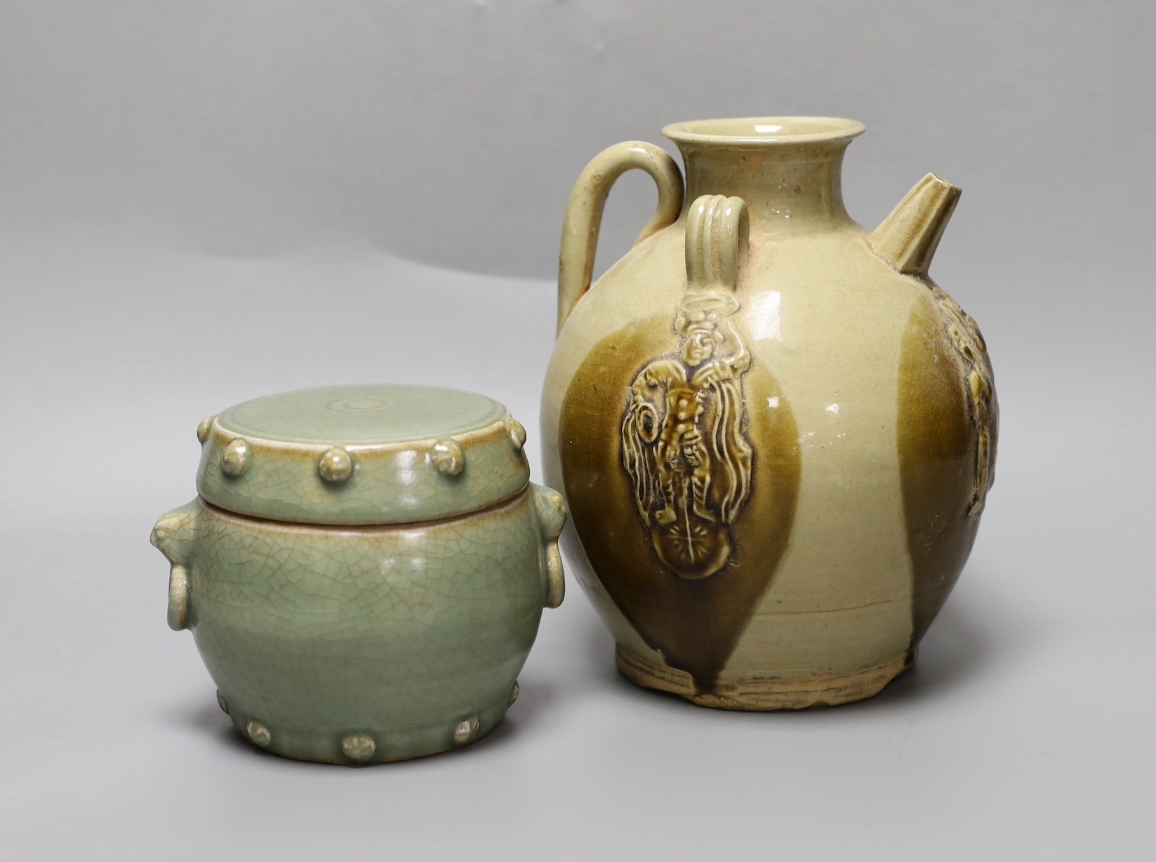 A Chinese buff-glazed wine pot and celadon jar and cover, 18.5cm